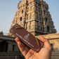 Tamil product held in hand near temple